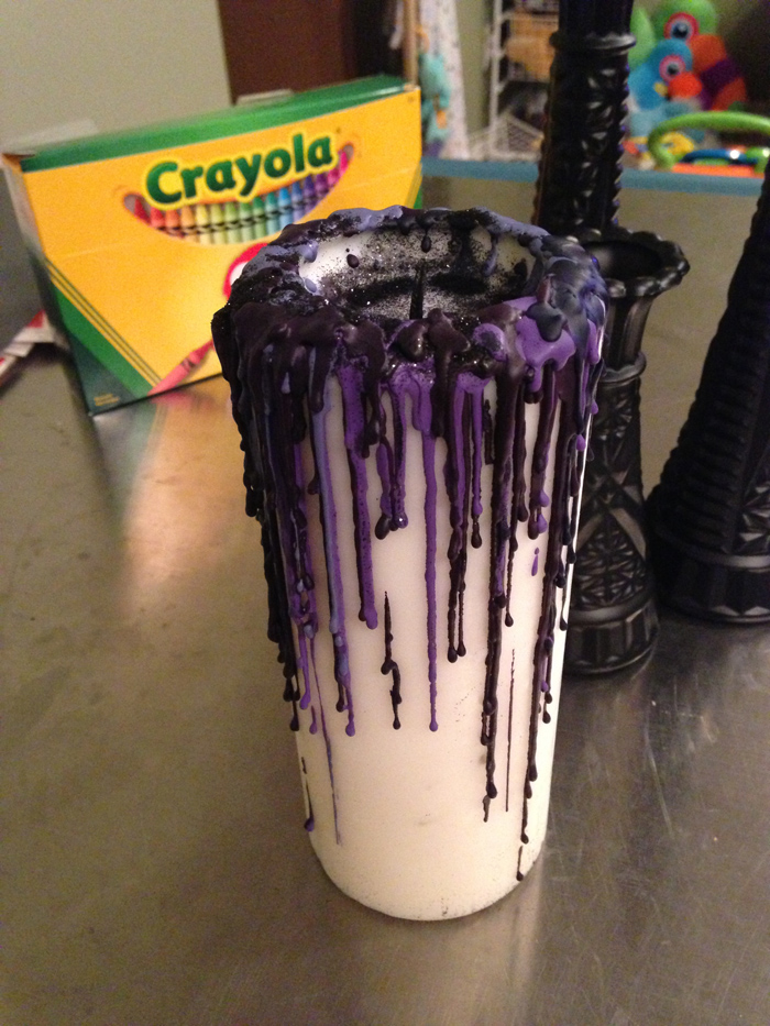 Crayon drippings on white candle