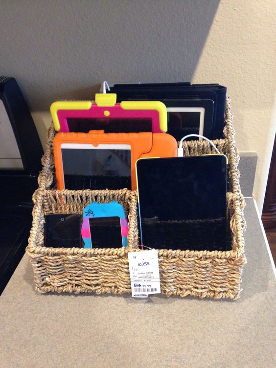 multiple devices stored in a cheap wooden basket