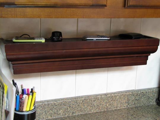 brown wooden shelf with phones atop