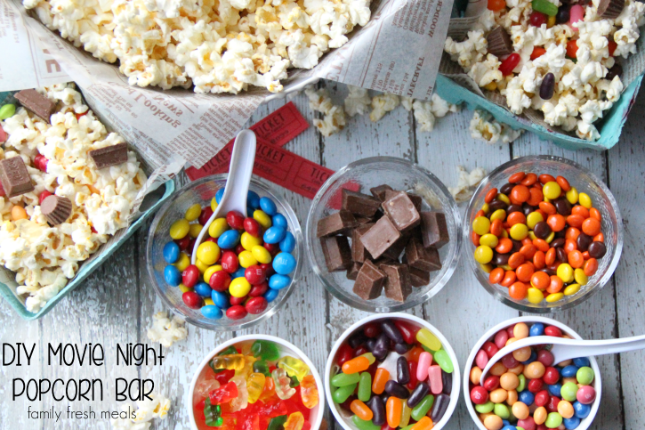 DIY popcorn bar for slumber parties and movie nights - some ingredient ideas for a sleepover party popcorn bar include m and ms, chocolate bars, reeses pieces, gummy bears, and mike n ikes