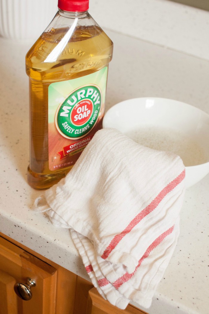 A bottle of Murphy's Oils Soap with a small bowl and cleaning rag.