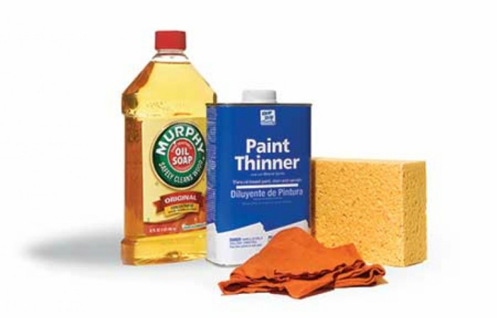 A bottle of Murphy's Oils Soap with can of paint thinner, a sponge and a rag