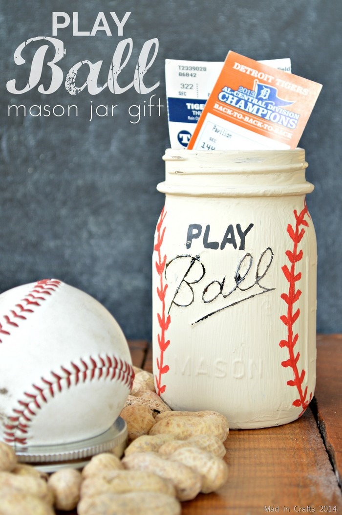 mason jar painted like a baseball with sporting event tickets poking out of the top of the jar