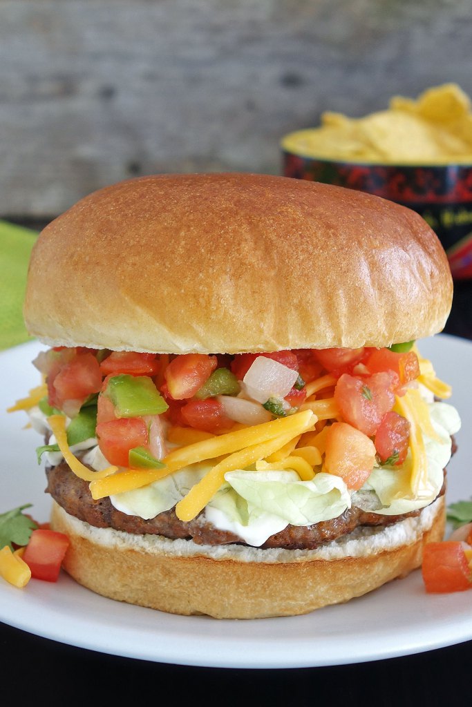 Close up of Taco burger piled high with salsa and fixin's