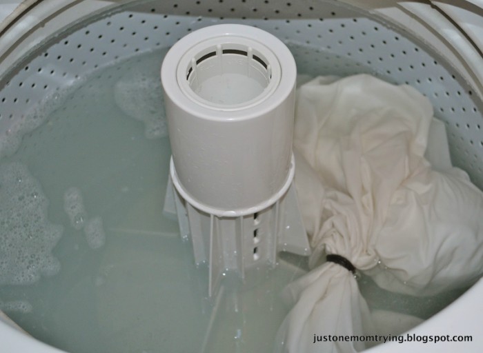 stuffed toy being washed inside a pillowcase in the washing machine