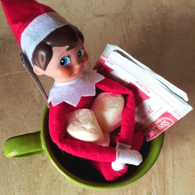 Elf On The Shelf sitting in a mug