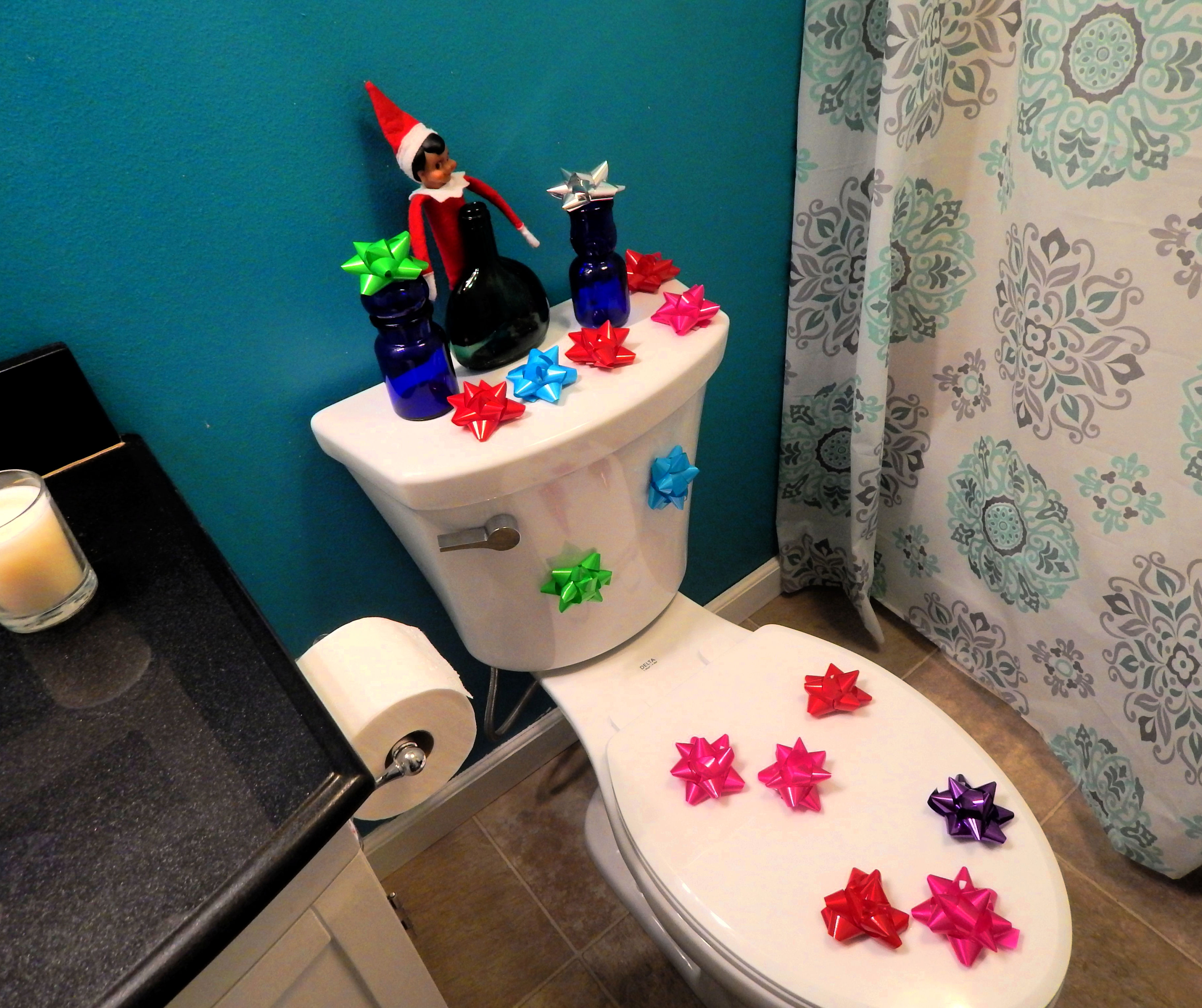 toilet with christmas bows stuck to it