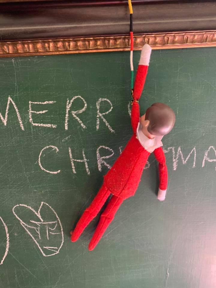 Elf on the Shelf Hanging From Chalkboard