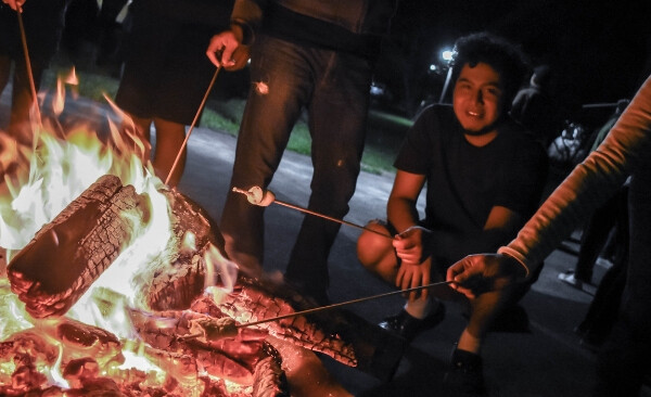 cooking s'mores around the campfire