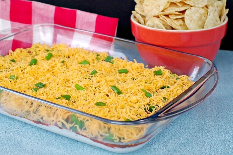 Enjoy Mexican appetizers like this easy layered nacho dip