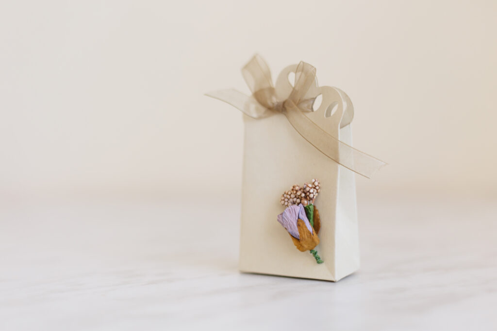 Genius Gift Card Ideas That Aren’t Just An Envelope - beautiful cream-colored gift bag with light purple paper flowers
