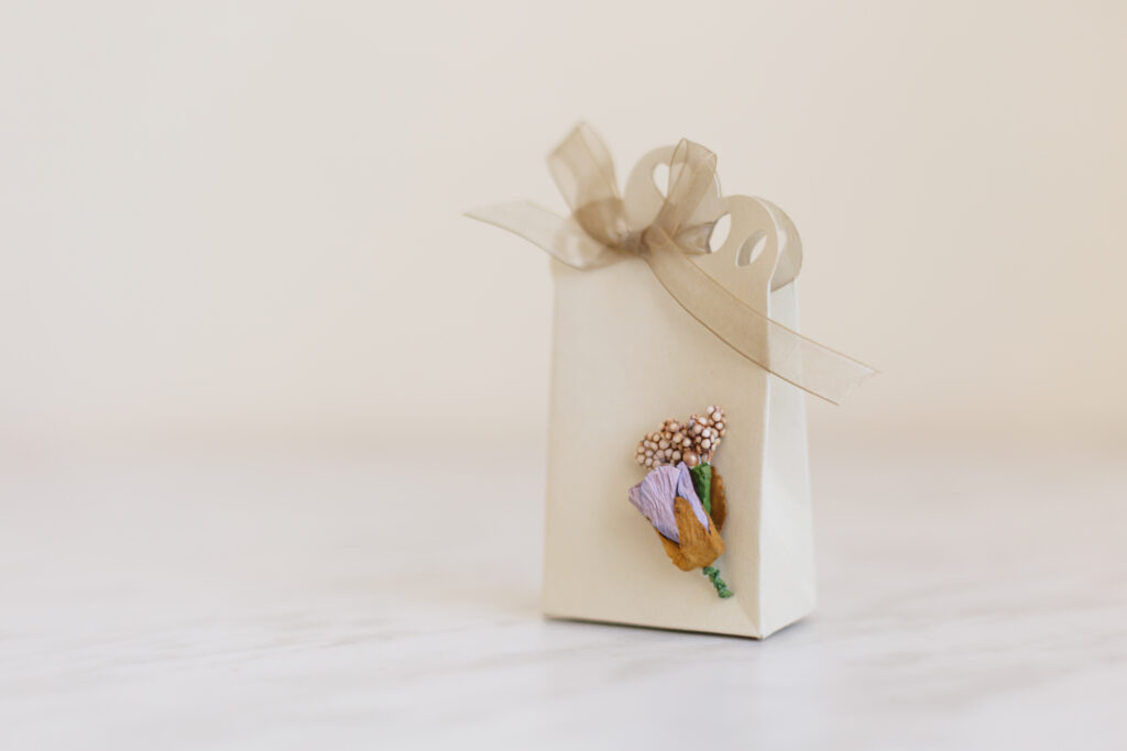 Genius Gift Card Ideas That Aren’t Just An Envelope - beautiful cream-colored gift bag with light purple paper flowers