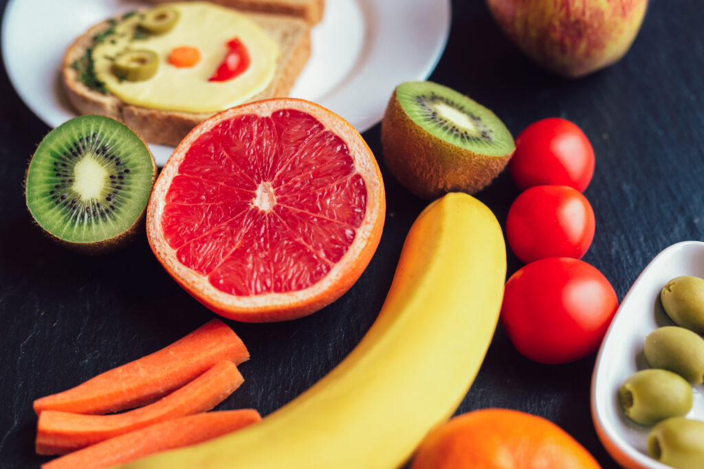 Easy, Healthy After School Snacks Kids Will Beg For - slices of fruit and toast with cheese and olive face.