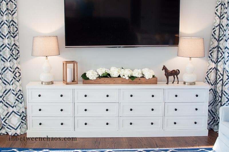 long white media console with black knobs