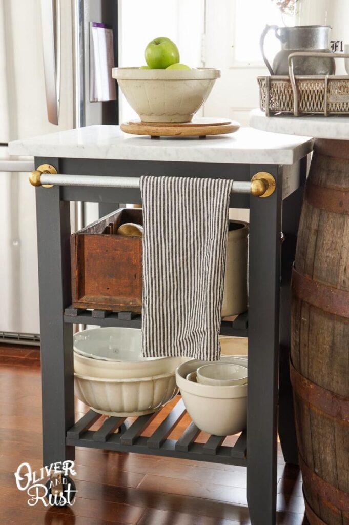 dark grey farmhouse style kitchen cart with white marble top