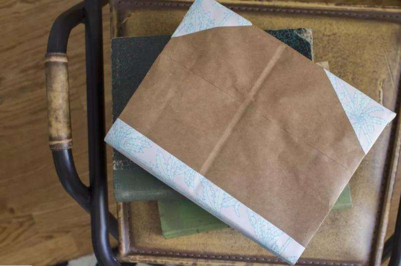 Textbook with a brown paper bag cover.