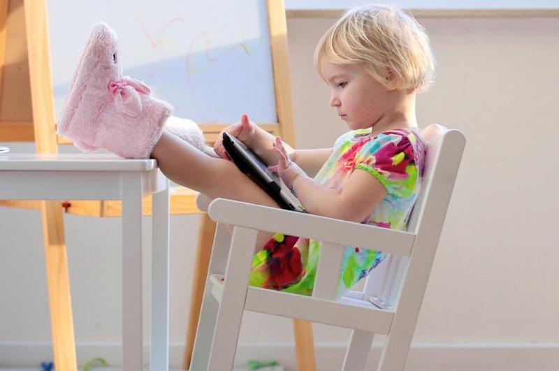 toddler using ipad to play fun learning games for kids