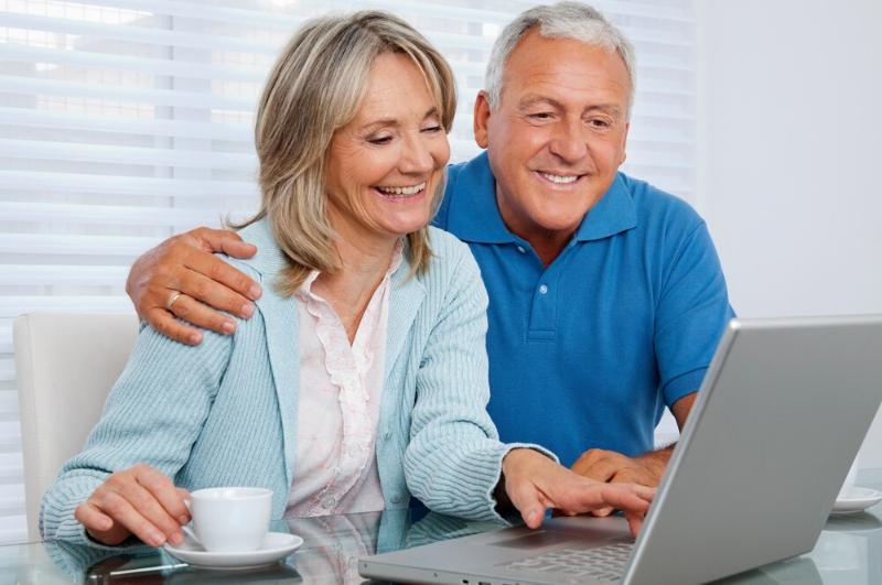 senior couple enjoying fun things to do at home on a laptop