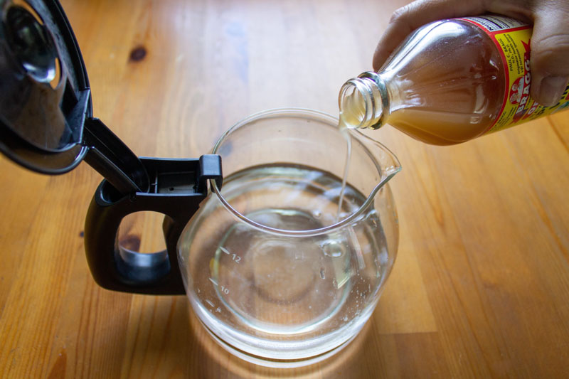 Coffee maker with vinegar and water mixture to clean it