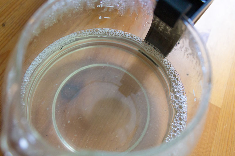 Soapy coffee carafe after cleaning a coffee maker