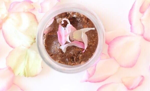 sugar scrub in a jar surrounded by rose petals