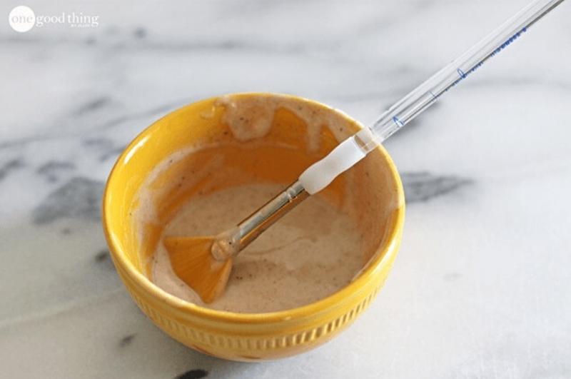 yogurt and honey face mask in a yellow bowl with a brush