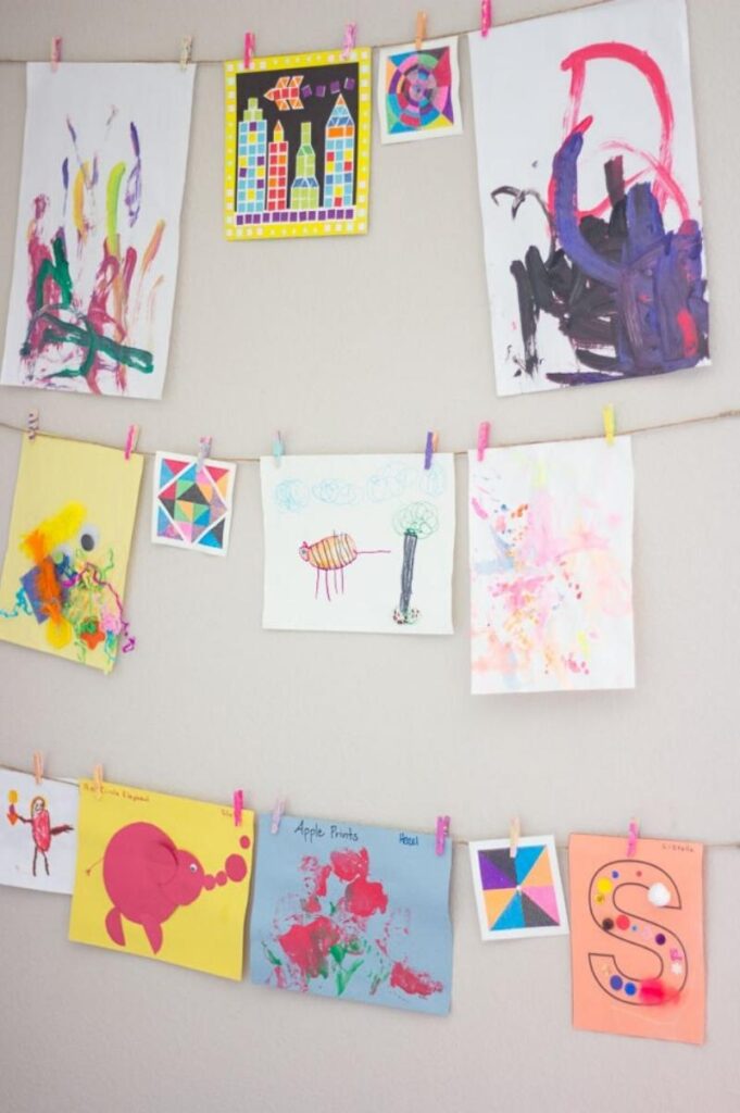 kids art hanging on walls from DIY twine ropes and clothespins