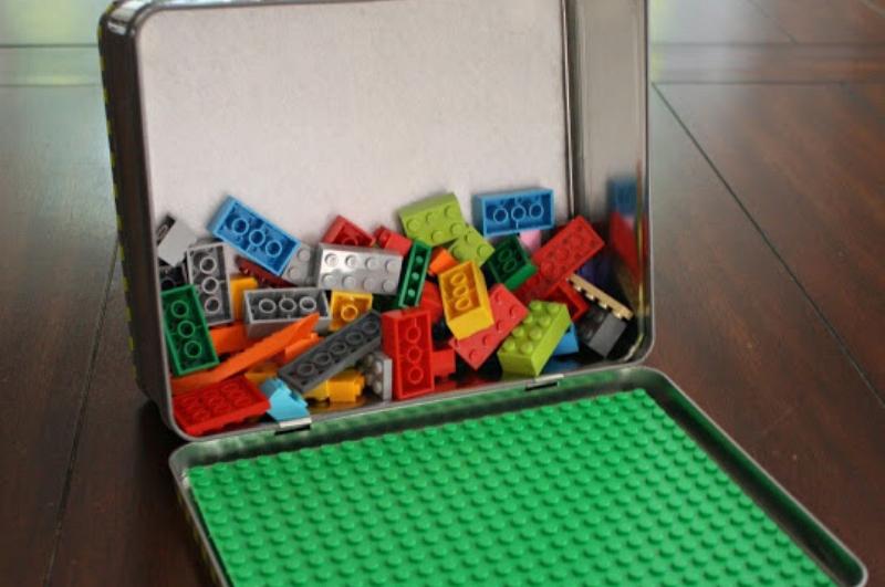 metal lunchbox with Lego board and Legos