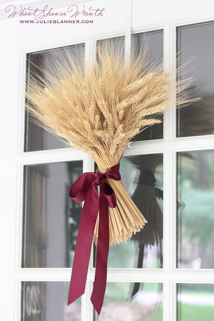 wheat sheave fall wreath hanging on a door