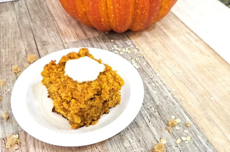 pumpkin baked oatmeal square with a dollop of Greek yogurt on a plate