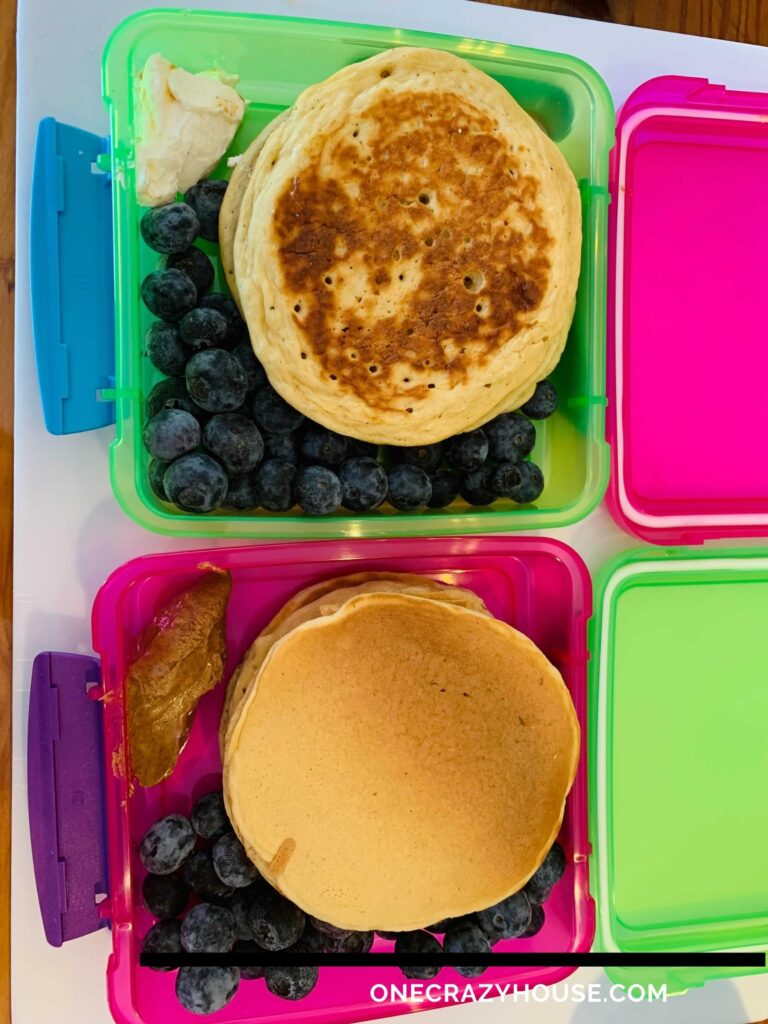 freezer container with individually frozen pancakes and blueberries