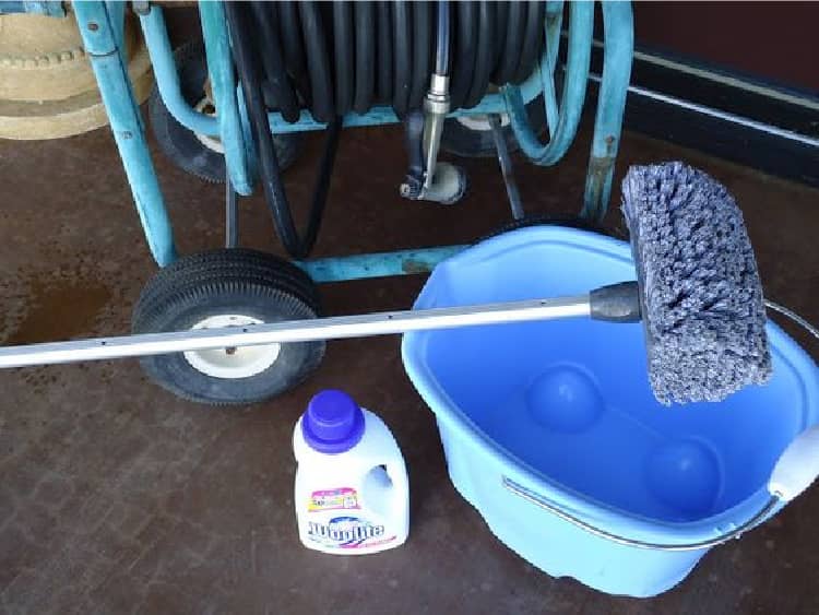 A bucket of water, soft brush and woolite