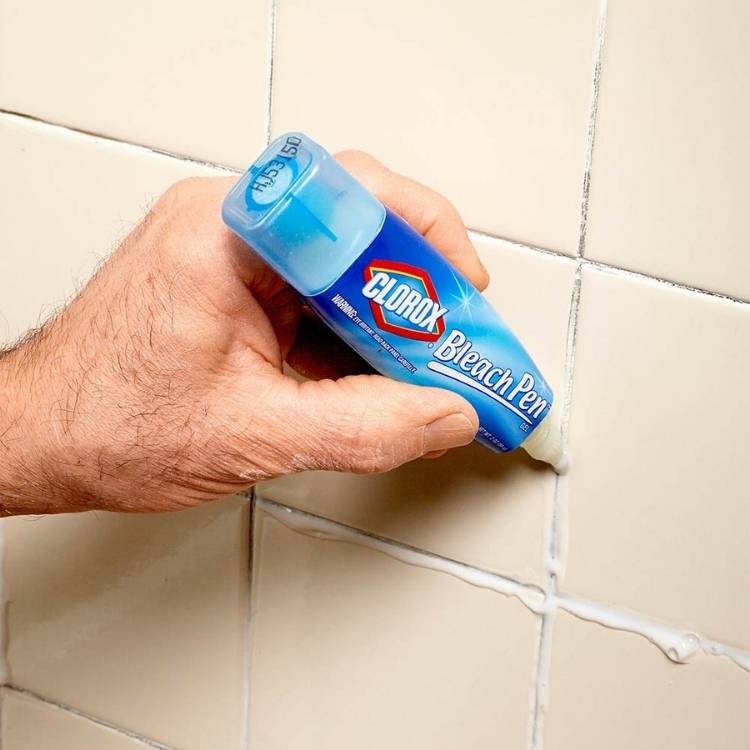 bleach pen being applied on bathroom grout