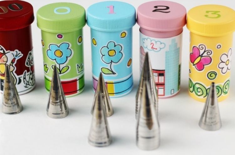 Clever Frosting Tip Storage from repurposed pill bottles with labels and tip sizes on lids