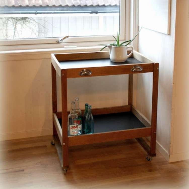 Wooden repurposed changing tables into little rolling cart with lined black tops