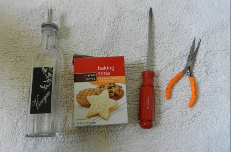 vinger, baking soda, screwdriver, and long nose pliers for cleaning the drain