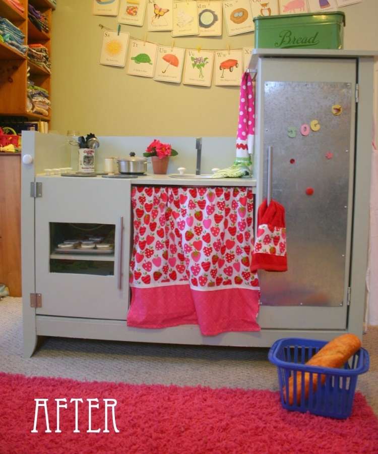 Changing table converted into a custom kids kitchen with strawberry curtains and kitchen magnets. 