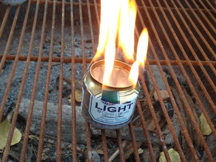 cold-weather-camping image of a beer can used to create a campfire