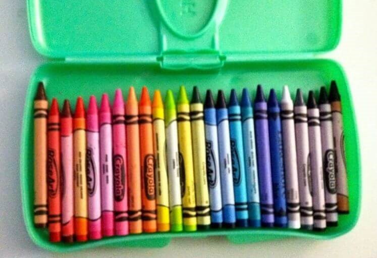 Crayons in an empty travel baby wipes container