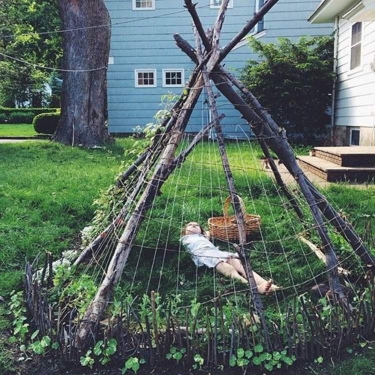 Creat a Backyard Teepee from Branches and Twigs - 19 Family Friendly Backyard Ideas For Making Memories - Together - One Crazy House