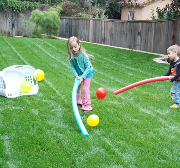 Picture of kids using pool noodles, balls, and a laundry basket to play hockey