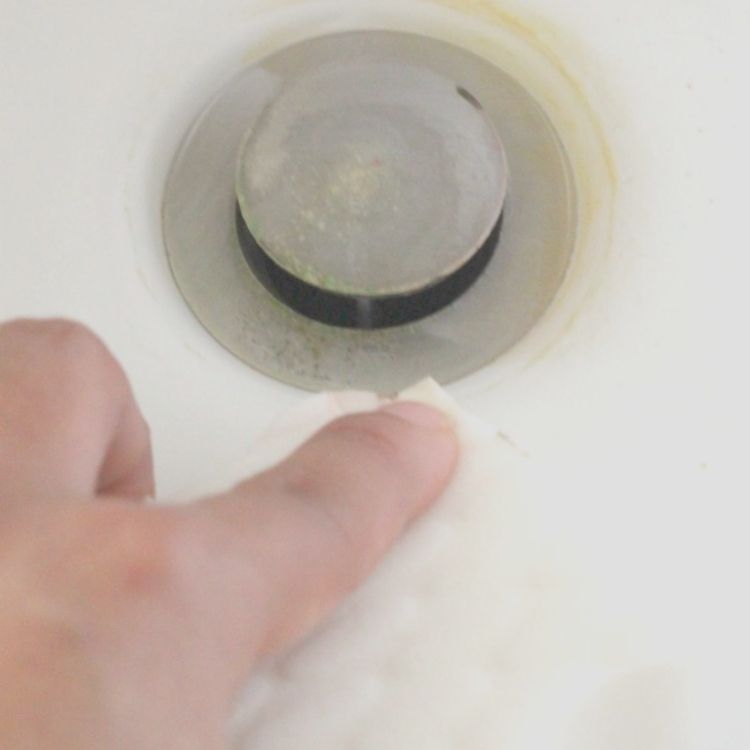 How to clean bathtub by Scrubbing a drain with magic eraser