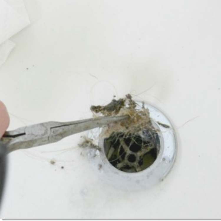 How to clean bathtub - Picking hair and gunk out of the drain with pliers