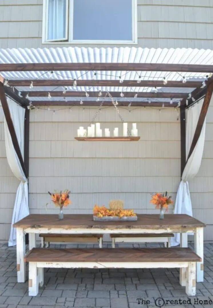 Wooden pergola with a table and benches underneath - patio diy ideas