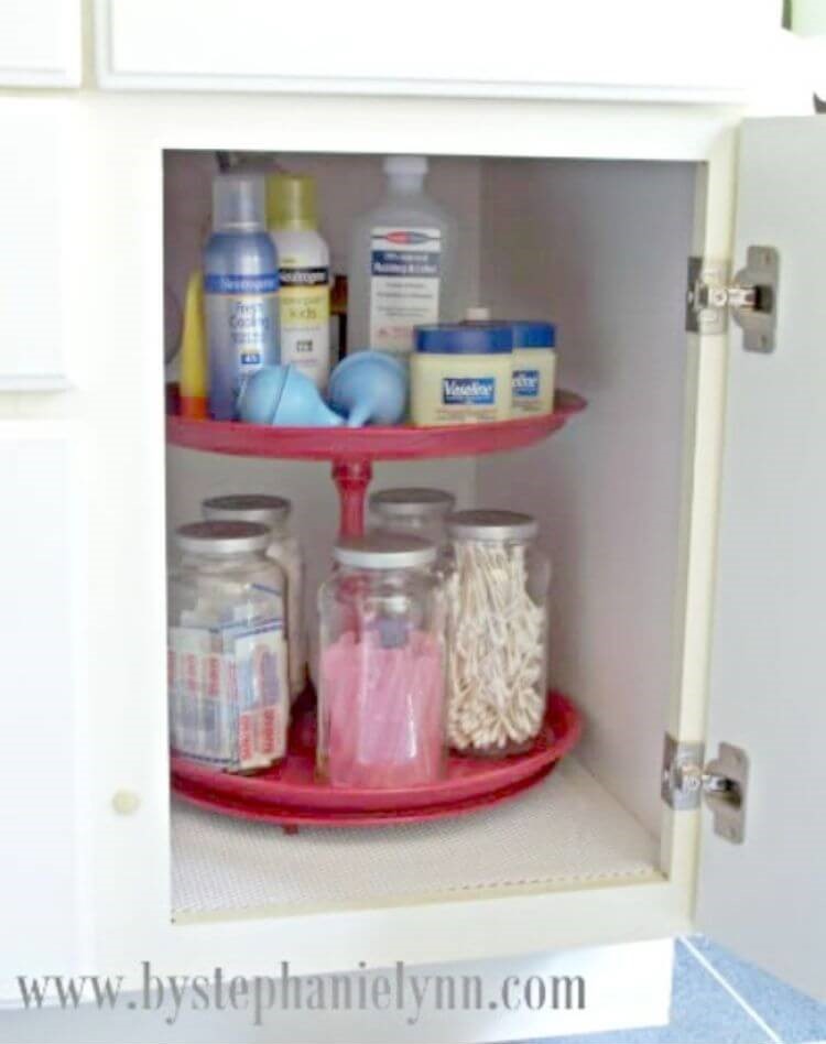 DIY lazy susan filled with items you store in the bathroom like cotton balls, cotton swabs, and Vaseline