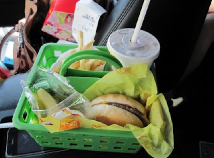 Car hack using a dollar store shower caddy used to organize a fast food meal