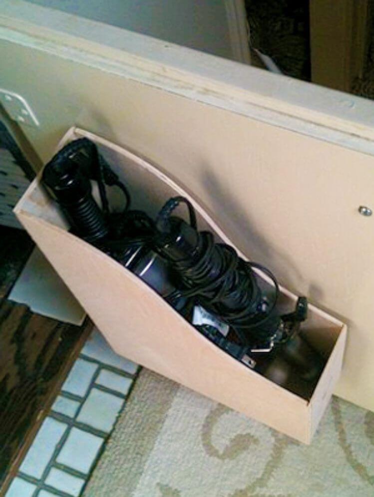 Under bathroom sink storage for hair styling products - file folder holing curling irons and other hair styling tools