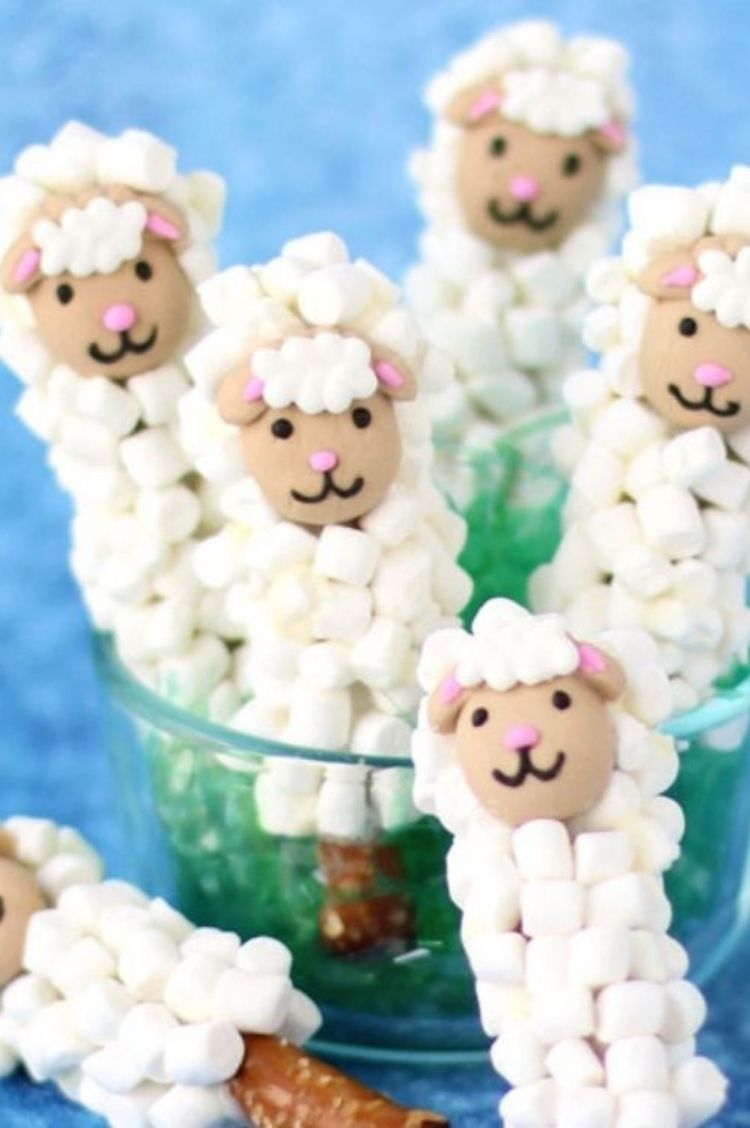 Pretzel sticks covered with white chocolate and tony marshmallows with little black icing for faces
