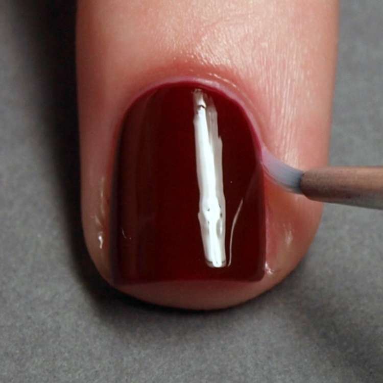 Remove extra polish on cuticles using a nail brush