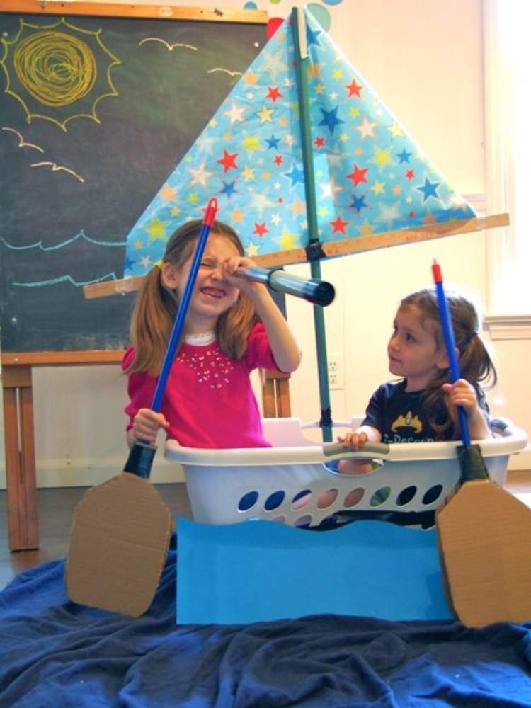 Picture of kids using laundry basket as a sailboat